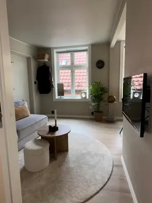 a living room with a couch and a table at Cosy flat in historical lane in Bergen