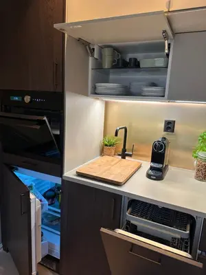 a kitchen with an open refrigerator with a sink at Cosy flat in historical lane in Bergen