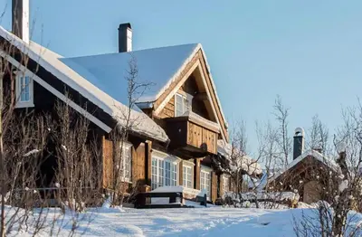 a wooden house with snow on the roof at Family Cabin For Many In The High Mountains in Hovet