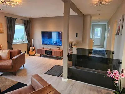 a living room with a large flat screen tv at Newly renovated apartment in beautiful Haramsøy in Ålesund
