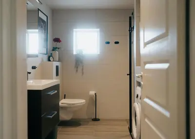 a bathroom with a toilet and a sink at Newly renovated apartment in beautiful Haramsøy in Ålesund