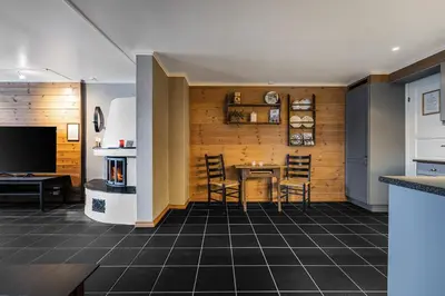 a kitchen with a table and chairs in a room at Spacious Family Apartment in Hemsedal, Ski In-Out, Sauna, 30m from Skarsnuten hotell in Hemsedal