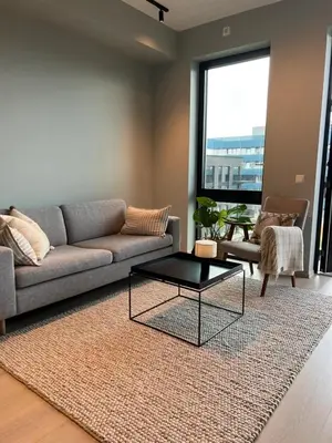 a living room with a couch and a coffee table at LADE - leilighet i Ringve Pluss in Trondheim