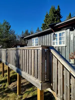 a wooden ramp leading up to a house at Traditional Family Cabin Near Rabalen in Bagn