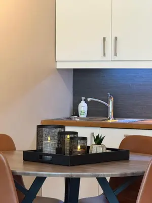 a table with a tray with candles on top of it at Geiloholtet central city apartment in Geilo