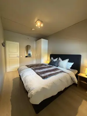 a bedroom with a large bed in a room at Geiloholtet central city apartment in Geilo