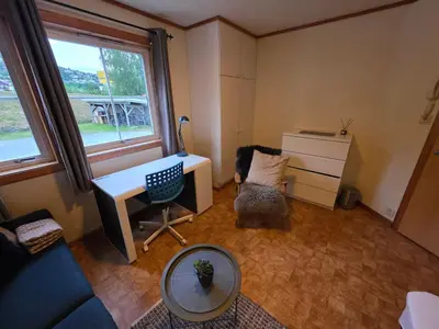 a room with a desk and a chair and a window at Rom 3 i bufellesskap in Sogndal