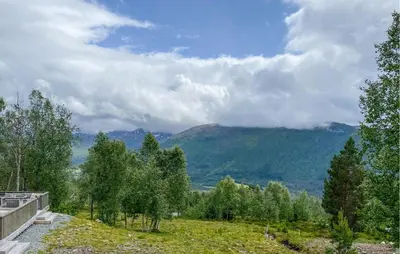 a view of a mountain with trees in a field at Cozy Home In Hornindal With Sauna in Hornindal