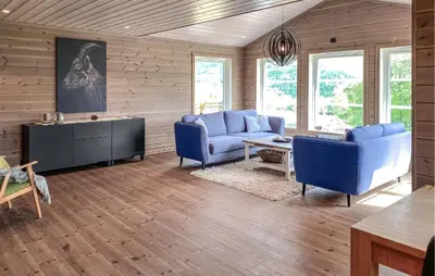 a living room with two blue couches and a table at Cozy Home In Hornindal With Sauna in Hornindal
