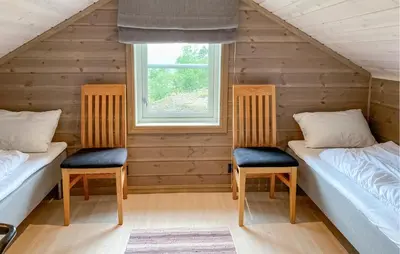 two beds in a room with a window at Cozy Home In Hornindal With Sauna in Hornindal