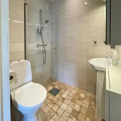 a bathroom with a toilet and a shower and a sink at Private room with a view and garden - 12 min from the city center in Bergen