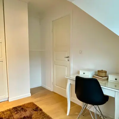 a room with a desk and a black chair at Private room with a view and garden - 12 min from the city center in Bergen