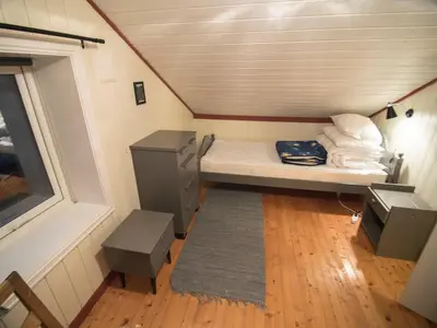 a small room with a bed and a window at Hansali Holiday Home in Fjarland