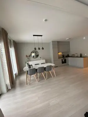 a kitchen and dining room with a white table and chairs at Modern apartment in beautiful Lofoten in Lii