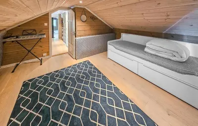 a small room with a bed in a cabin at Awesome Home In Vinje With Sauna in Trovatn