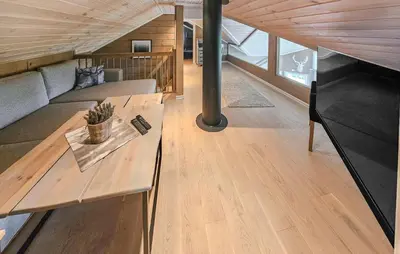 a living room with a couch and a table at Awesome Home In Vinje With Sauna in Trovatn