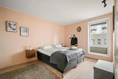 a bedroom with a bed and a window at Modern & Spacious City Apartment in Bergen