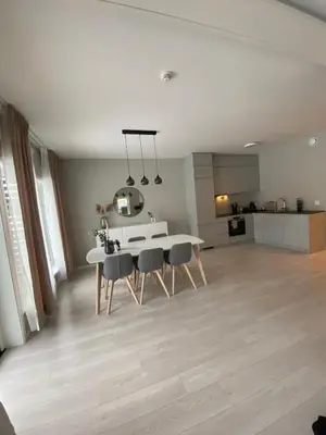 a kitchen and dining room with a white table and chairs at Modern apartment in beautiful Lofoten in Lii