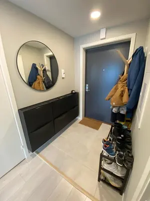 a hallway with a mirror and a bunch of shoes at Modern apartment in beautiful Lofoten in Lii