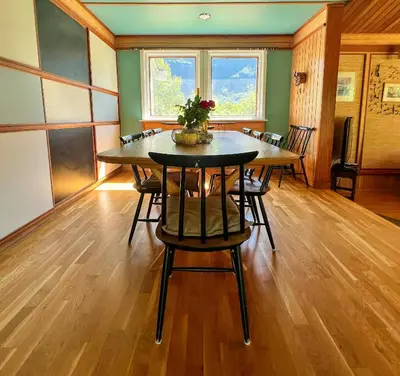 a dining room with a table and some chairs at Historic Cabin By Lærdal River in Tønjum