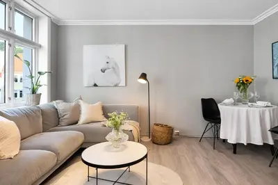 a living room with a couch and a table at Charming Apartment, Walk to Everything in Bergen in Lii