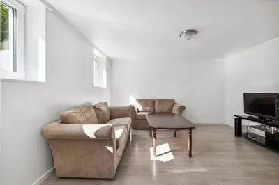 a living room with a couch and a tv at Family & Friends Space in Råholt in Lii