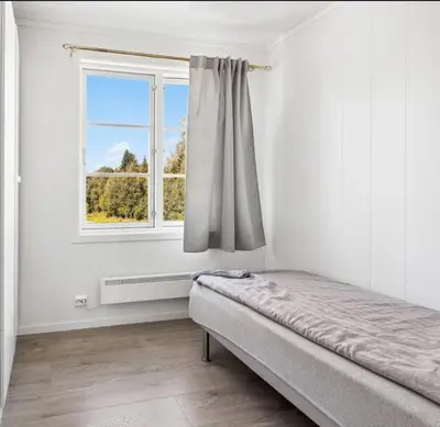 a bedroom with a bed and a window at Family & Friends Space in Råholt in Lii