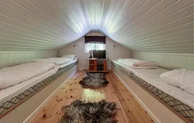a room with two beds and a tv in it at Gorgeous Home In Sjusjøen With Sauna in Sjusjøen