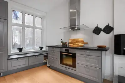 a kitchen with gray cabinets and a stove top oven at Unique and Spacious Home in Bergens Most Charming Area in Bergen
