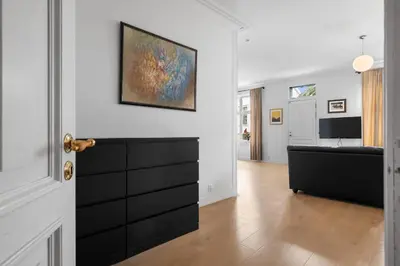 a living room with a couch and a painting on the wall at Unique and Spacious Home in Bergens Most Charming Area in Bergen