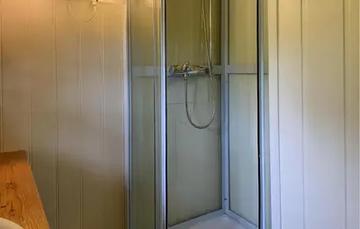a shower with a glass door in a bathroom at 1 Bedroom Amazing Home In Tingvoll in Tingvoll