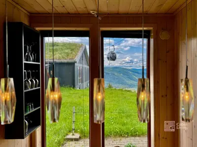 a room with a window with a view of a mountain at Ski-In Out apt Hafjell - Sauna and Stunning Views in Hafjell