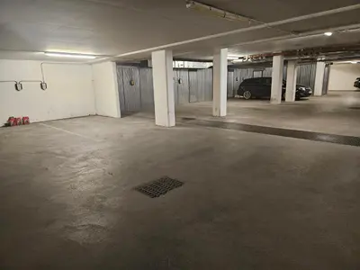 an empty parking garage with a car parked in it at Cozy apartment Trondheim, free parking in the basement in Trondheim
