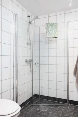 a bathroom with a shower and a toilet at Cozy apartment Trondheim, free parking in the basement in Trondheim