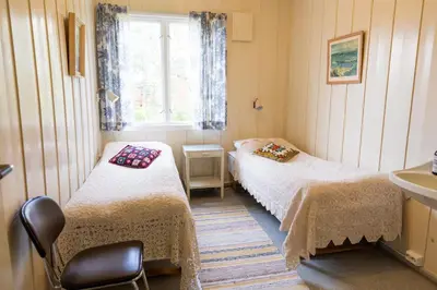 a small room with two beds and a sink at Voi Voi Bed & Breakfast in Røros
