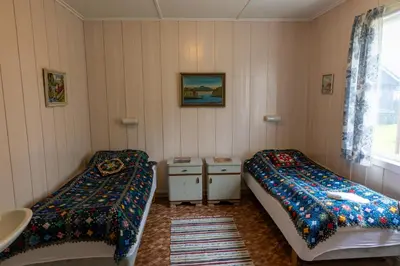 a room with two beds and a sink in it at Voi Voi Bed & Breakfast in Røros