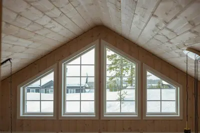 a room with three windows in a house at Authentic Family Cabin Experience At Sjusjøen in Sjusjøen