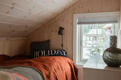 a bedroom with a bed and a window at Authentic Family Cabin Experience At Sjusjøen in Sjusjøen