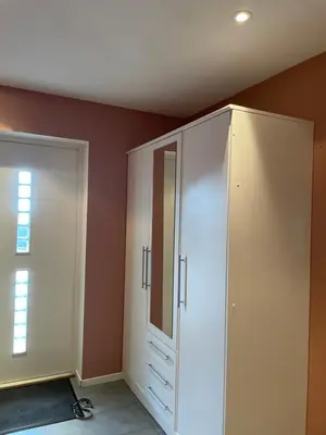 a room with a white cabinet and a mirror at Panorama leilighet in Lii