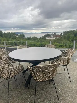 a white table and chairs on a patio at Panorama leilighet in Lii