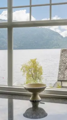 a large window with a view of a tree at The View in Sauda