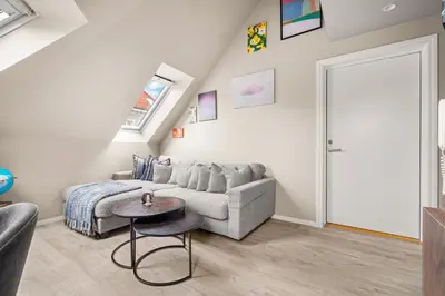 a living room with a couch and a table at Central & Modern Apartment in the Coziest Street in Bergen in Bergen