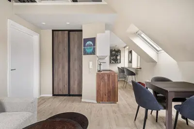a living room with a table and chairs at Central & Modern Apartment in the Coziest Street in Bergen in Bergen