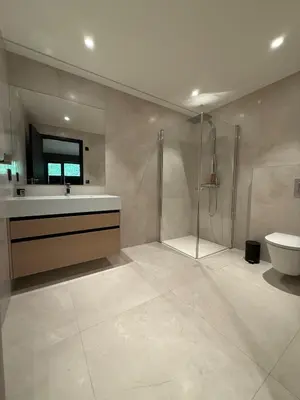 a bathroom with a shower and a sink and a toilet at Villa Vaaganeset in Lii