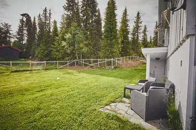 a yard with two couches sitting in the grass at Fisking i Valdres in Tisleidalen