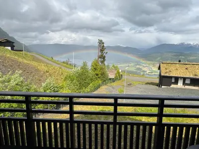 a view of a rainbow from a balcony at Flott leilighet på Voss i Tråstølsvegen med 3 soverom 6 sengeplasser in Skulestadmo