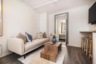 a living room with a couch and a table at Bergen pearl in historic street & easy check-in in Bergen