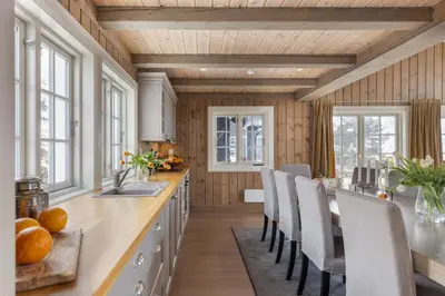 a kitchen with a table and chairs and windows at The national park is calling! in Garden