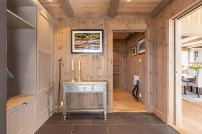a hallway with a fireplace in a wooden house at The national park is calling! in Garden