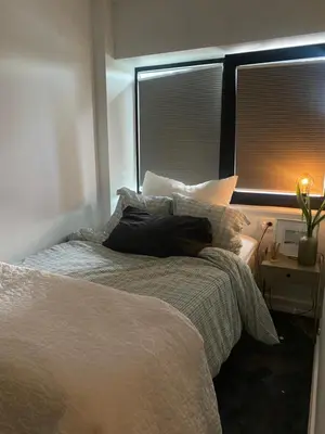 a bedroom with a bed with pillows and a window at Holiday apartment south Norway in Lii